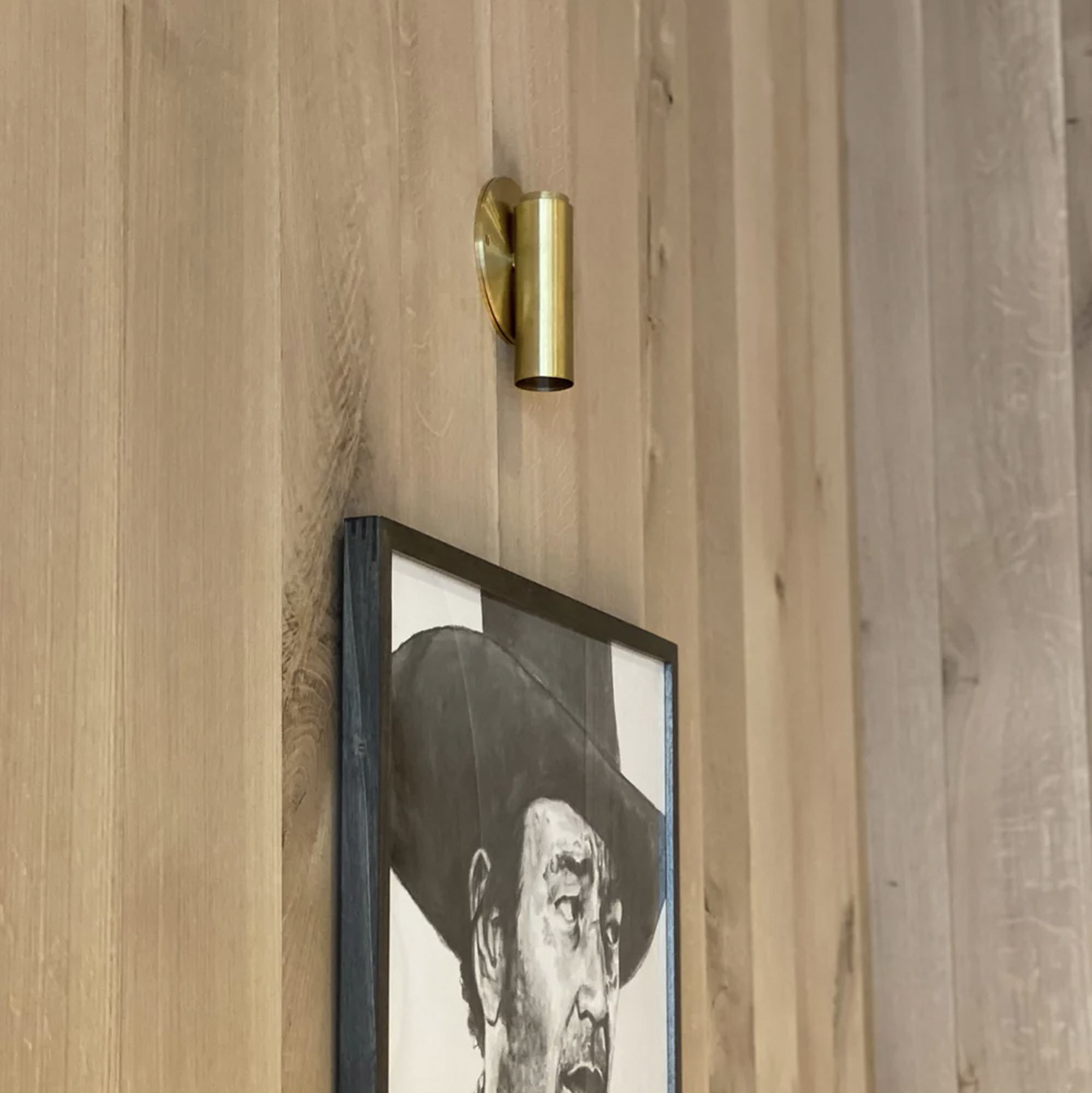Brass sconce on wood wall