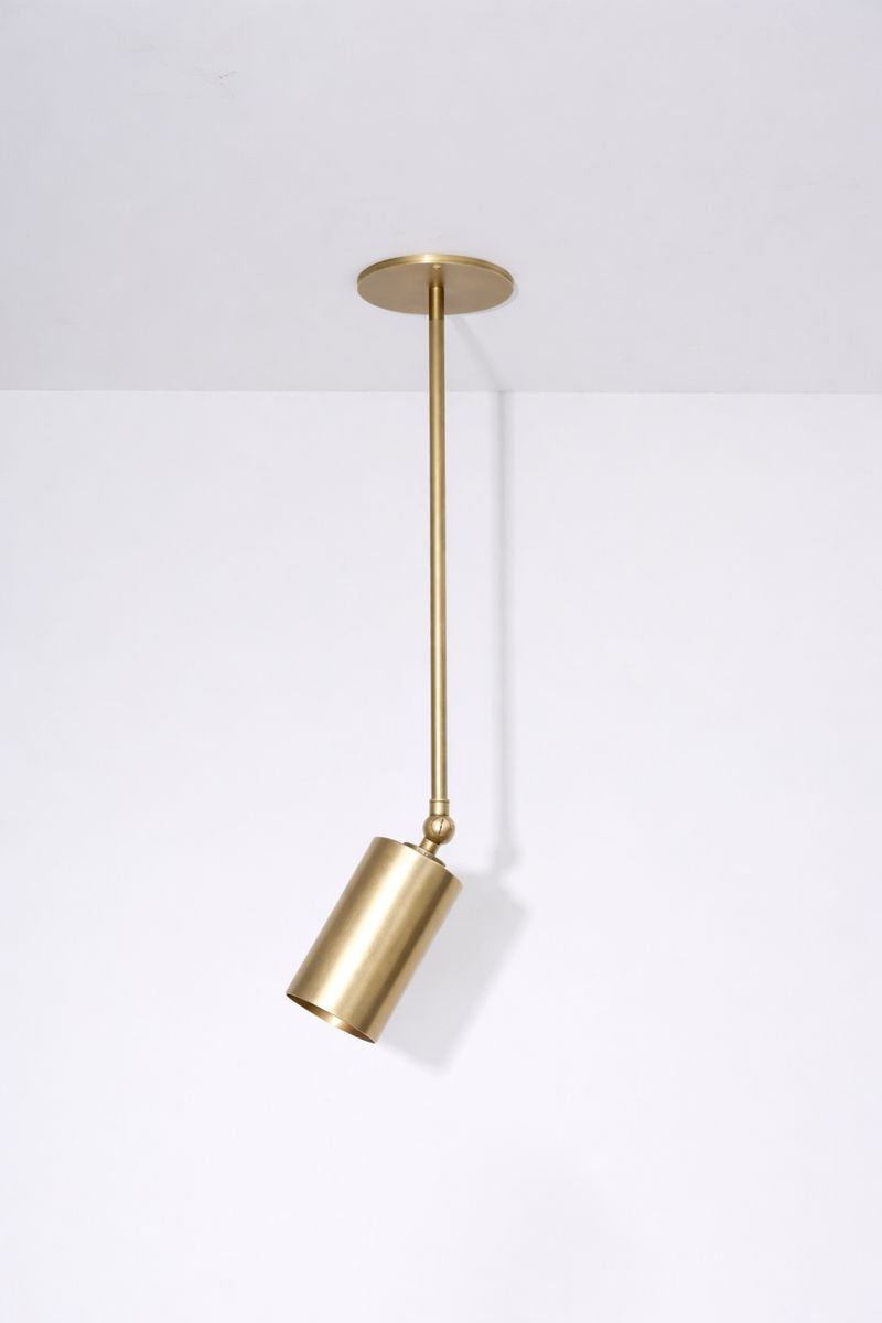 Brass pendant light fixture on a white background