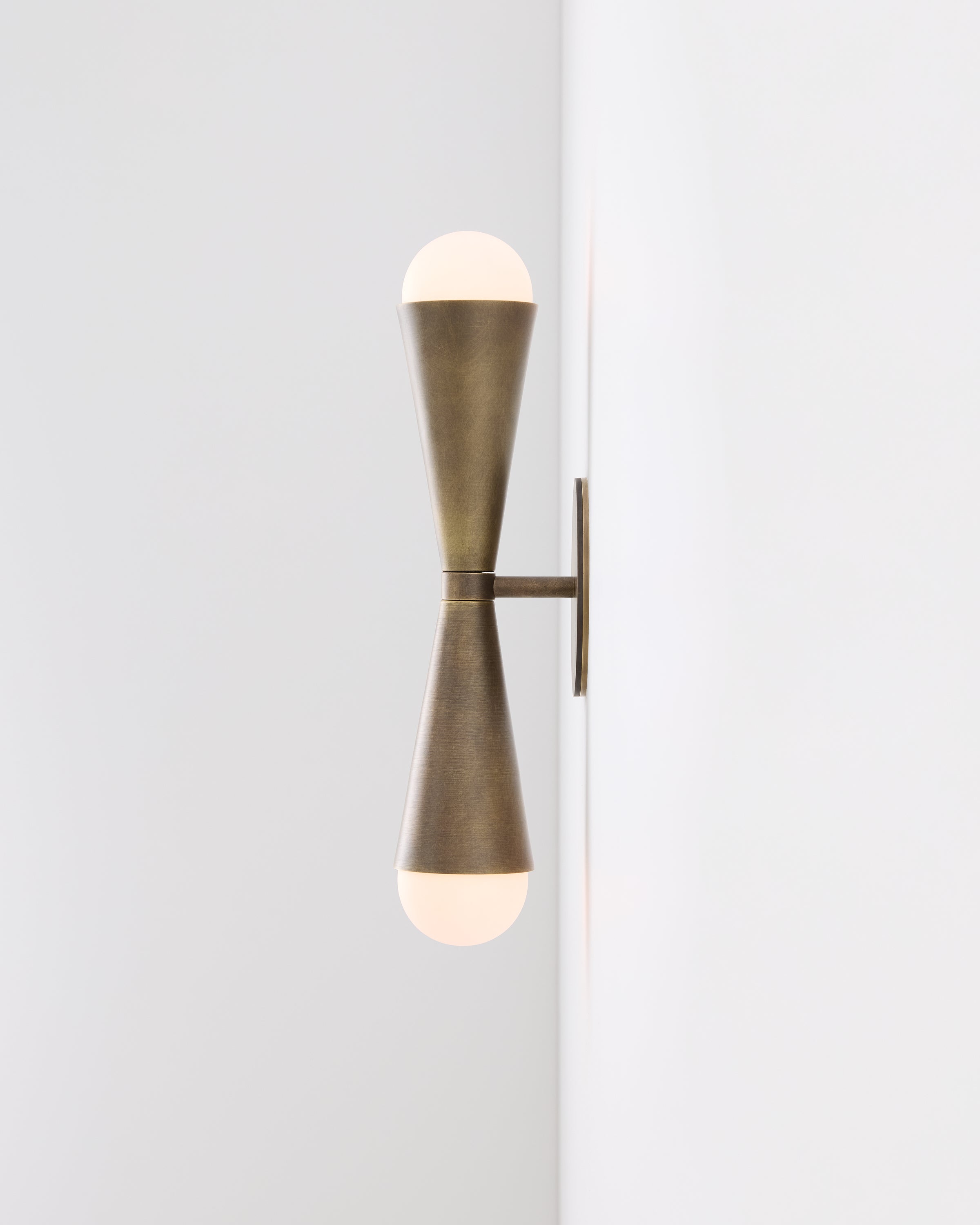 Sideview of Karma II up-down, two-light brass wall sconce