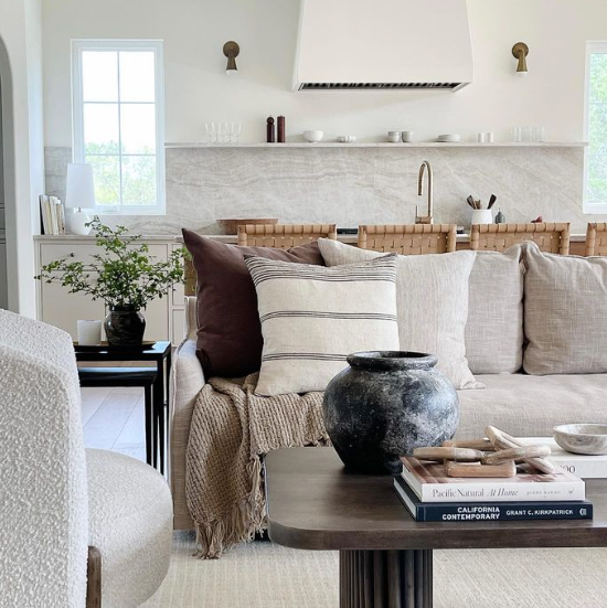 Open concept living room with Karma I brass wall sconces in kitchen