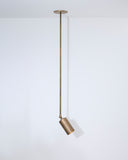 Brass pendant light hanging against a white background