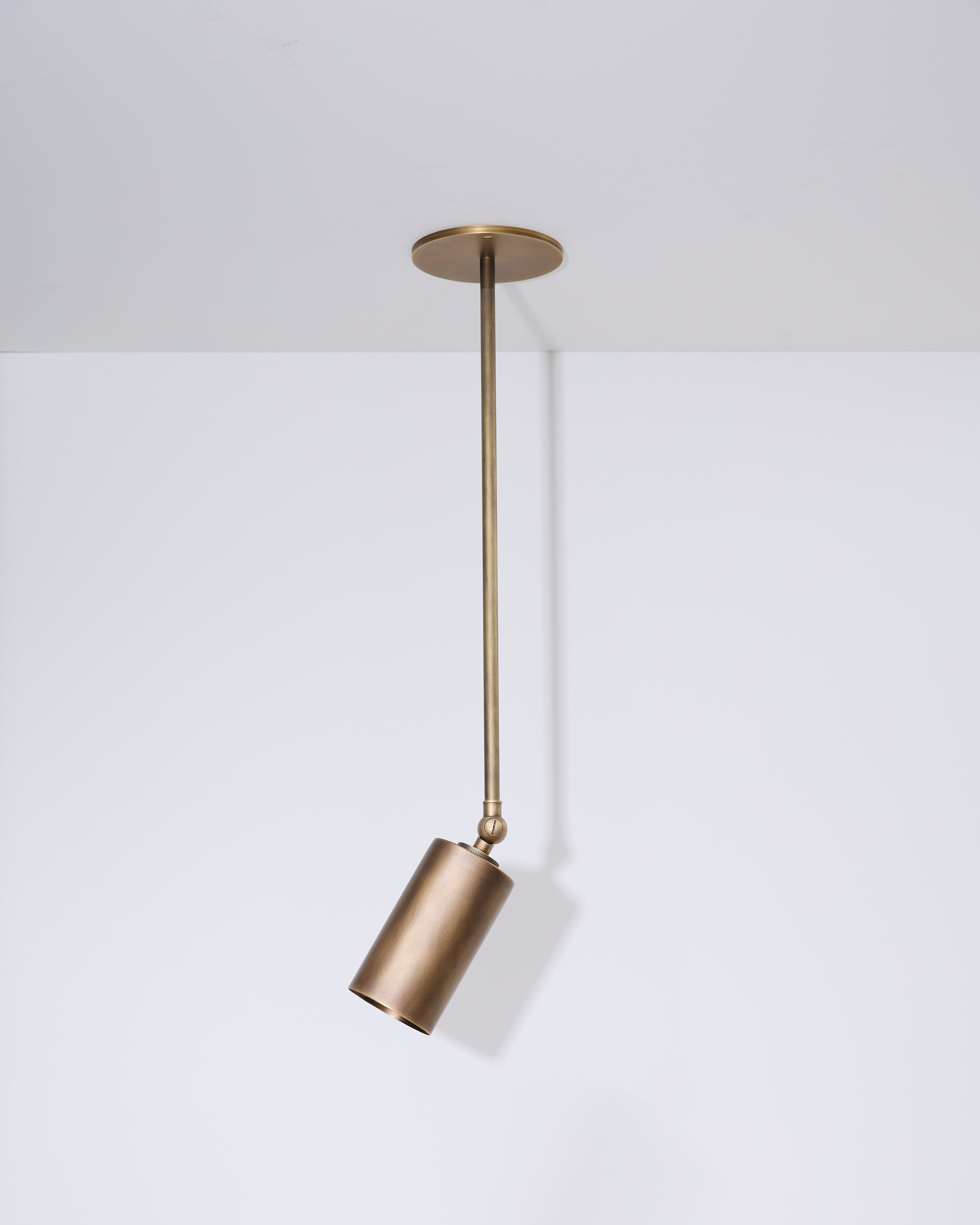 Brass pendant light fixture on a white background