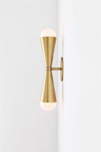 Gold wall-mounted light fixture on a white background