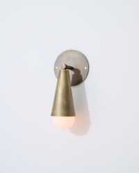 Sideview of Karma I brass wall sconce downlight in cone shape