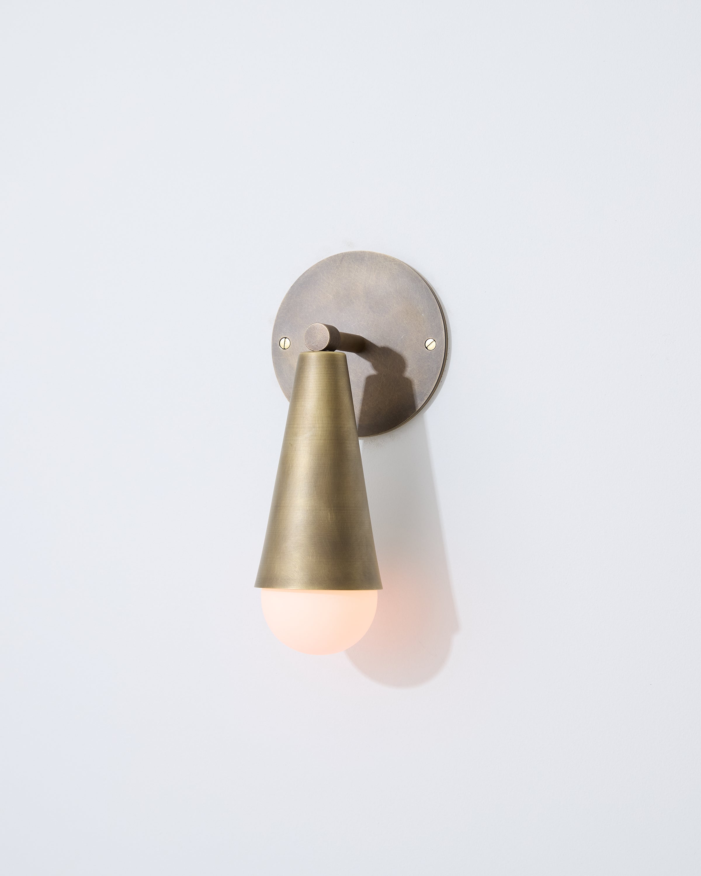 Sideview of Karma I brass wall sconce downlight in cone shape