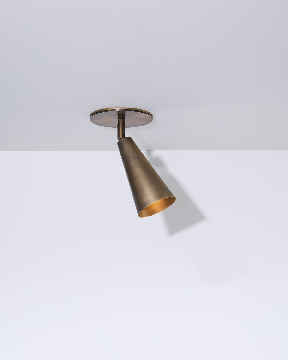 Bronze ceiling spot light fixture on a white background