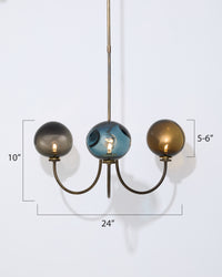 Chandelier with three spherical glass shades on a white background