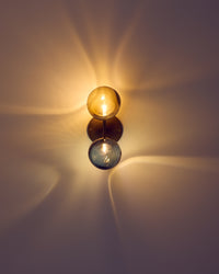 Wall-mounted light fixture casting a warm glow on a wall.