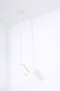 Modern white pendant light fixture on a white background